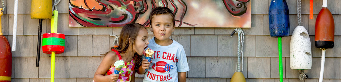 two young kids eating ice cream