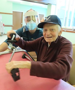 a veteran enjoys a hand bike ride with a recreation therapist