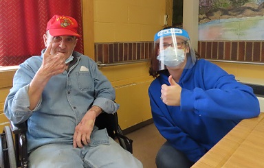 a veteran and a staff person give thumbs up