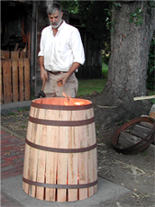taping metal hoops around a barrel