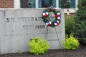 New Hampshire Veterans Home monument bearing the words: TO CARE FOR HIM WHO SHALL HAVE BORNE THE BATTLE