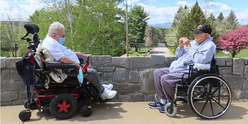 two veterans enjoy a talk on the patio