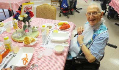 A resident enjoys special annual lobster meal